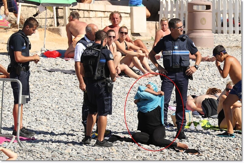 Police patrolling the promenade des anglais beach in Nice fine a woman for wearing a burkini. 23 August 2016. Please byline: Vantagenews.com