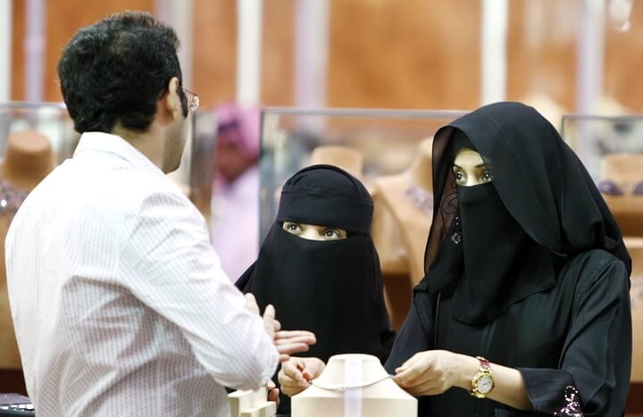 FILE - In this Saturday, March 21, 2009 file photo, Saudi women look at jewelry at a gold fair in Riyadh, Saudi Arabia. Human rights group Amnesty International says Saudi authorities have used an iron grip to consolidate power and unleashed a ruthless campaign of persecution against peaceful activists to silence criticism of the state. (AP Photo/Hassan Ammar, File)