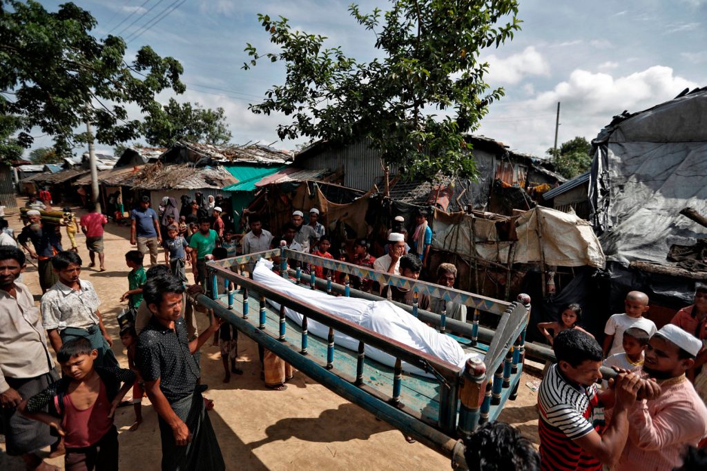 Rohingya refugees carry the remains of a man who, according to family members, succumbed to injuries inflicted by the Myanmar Army before their arrival in Cox's Bazar