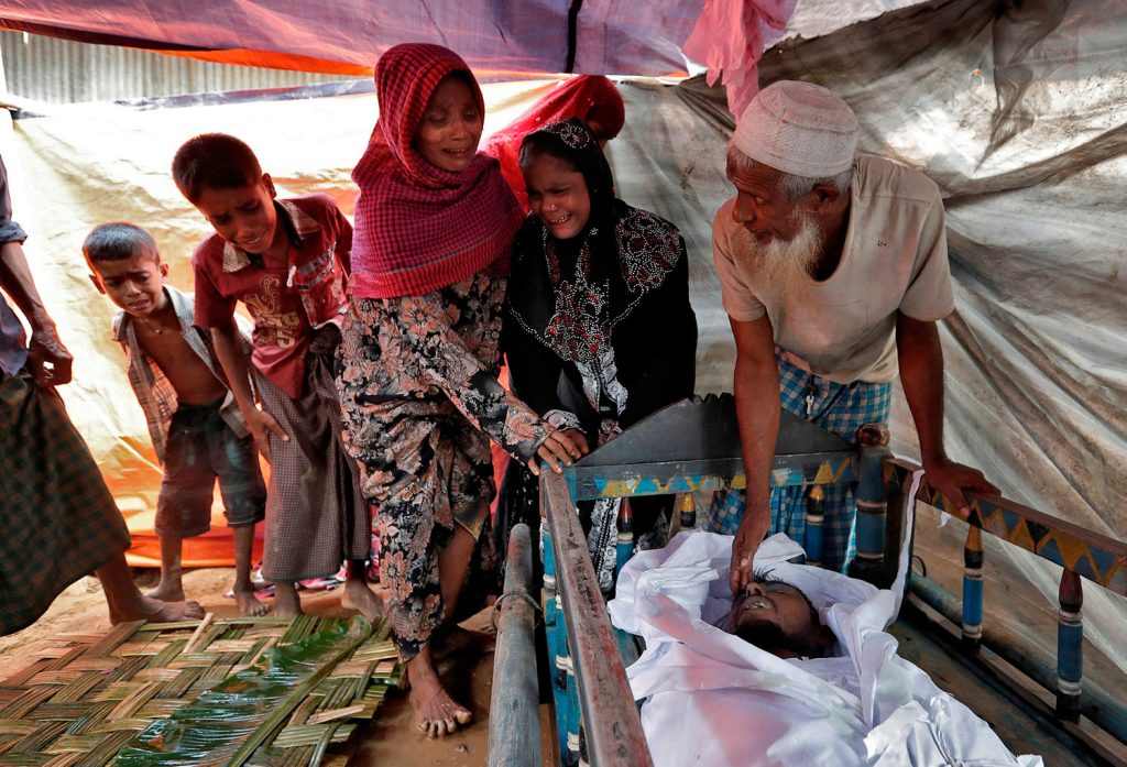 Rohingya refugees react as they see the remains of a family member who allegedly succumbed to injuries inflicted by the Myanmar Army before their arrival in Cox's Bazar