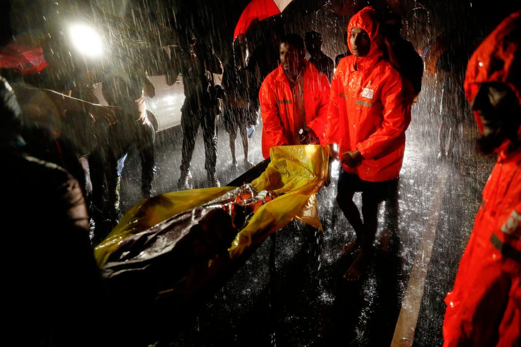 Bodies of Rohingya refugees are transported after their boat with passengers fleeing from Myanmar capsized off the Inani beach near Cox's Bazar