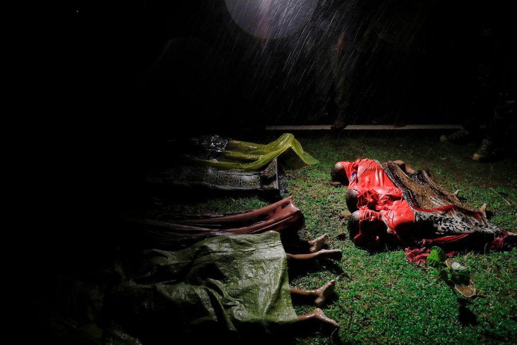 Bodies of children and other Rohingya refugees are covered after their boat with passengers fleeing from Myanmar capsized off the Inani beach near Cox's Bazar